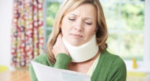 This image shows a woman analyzing a settlement agreement after a neck injury Mooresville personal injury lawyer