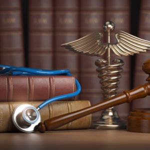 Image of a law book and stethoscope on desk of a Mooresville workers' compensation lawyer