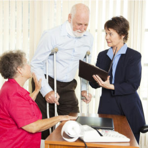 Image is of lawyer consulting injured client about the Charlotte maximum medical improvement 