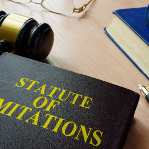 Image is of a statute of limitations book on the desk of a Concord car accident lawyer