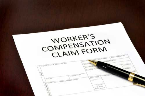 A worker's compensation claim form and pen