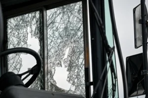 A bus windshield is cracked after being in a wreck and could use a bus accident lawyer from 1 Charlotte Injury Lawyers.