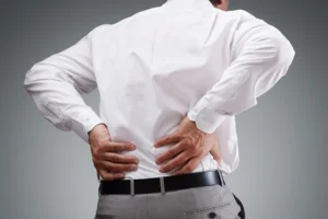 Man holding his back in pain, illustrating the assessment of damages in a personal injury claim