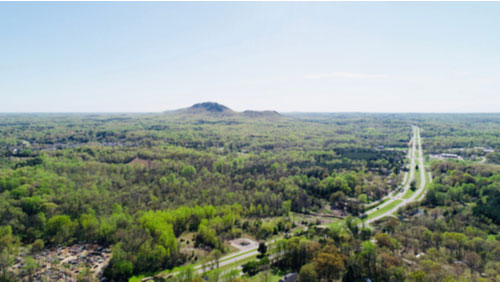 Aerial view of Gastonia with Crowder’s Mountain in the distance