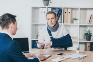 Attorney counseling injured man about Monroe workers' compensation claims process