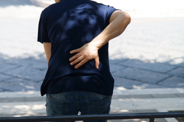 a person with back pain, concept of muscle strains