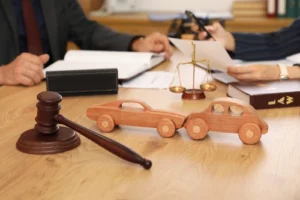 Car Accident Lawyer With Gavel and Wooden Cars