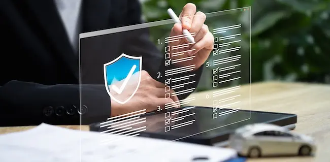 The commercial auto insurance claim process is being reviewed digitally with a policy protection checklist.