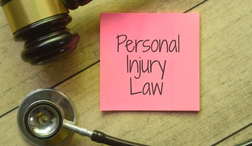 A pink sticky note reads Personal Injury Law with a stethoscope and gavel representing medical malpractice cases personal injury lawyers handle in North Carolina.