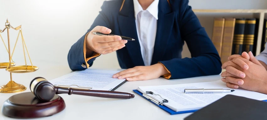 A female bus accident lawyer from 1 Charlotte Injury Lawyers is speaking with a client in North Carolina.