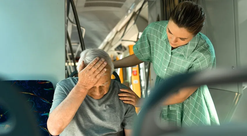 A female bus accident lawyer is assisting an elderly man after a bus accident in North Carolina.