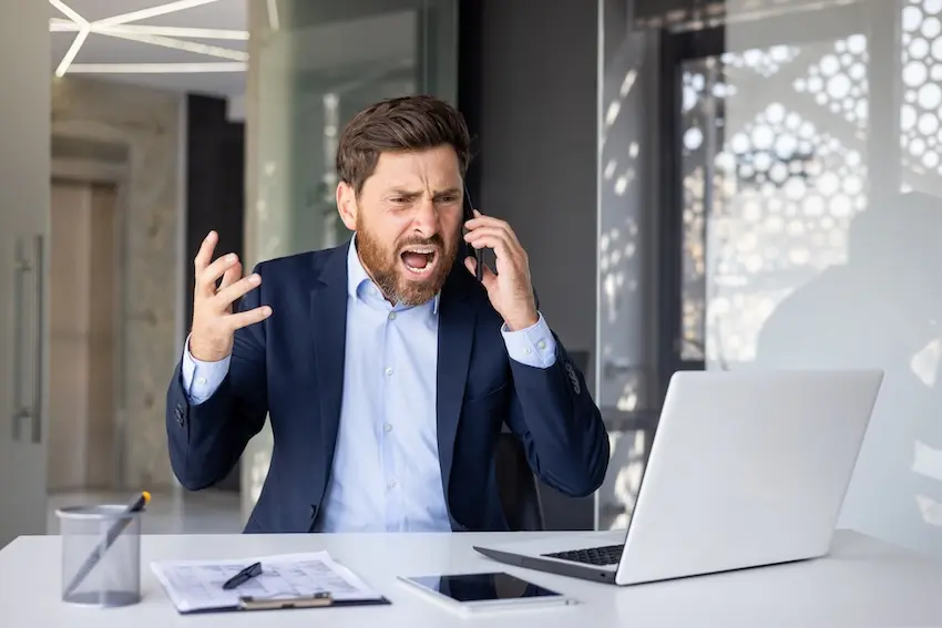 Insurance adjuster at desk reviewing settlement offers and claim documentation
