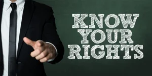 Photograph of an administrative law judge pointing to you to know your rights, emphasizing eligibility and the strict definition of total disability for many individuals.