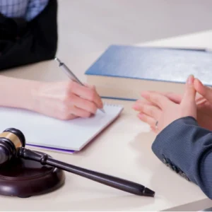 image is of lawyer and client discussing Charlotte workers compensation benefits