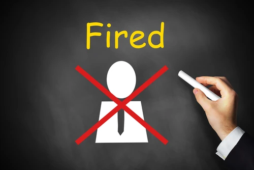 Hand crossing out an employee fired while on workers' comp in North Carolina.